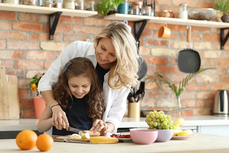 Mother and daughter preparing breakfast