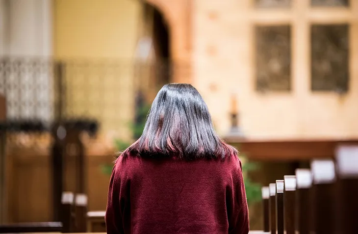 A woman praying at church