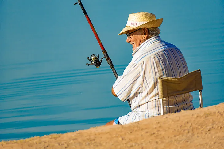 An old man fishing.