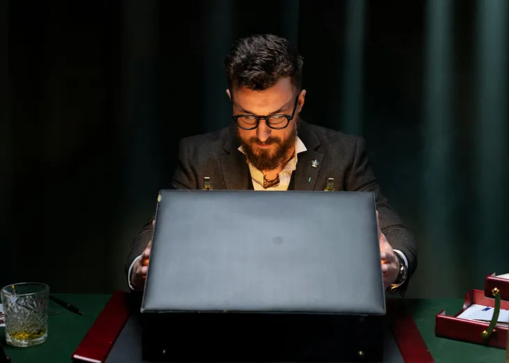 Man looking inside a briefcase.