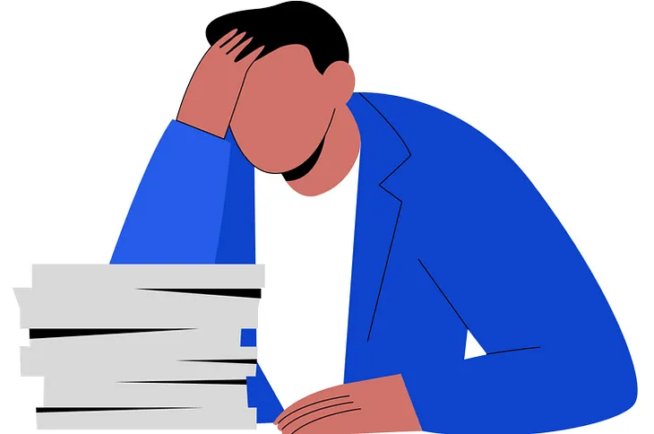 A person looking at a pile of paperwork.