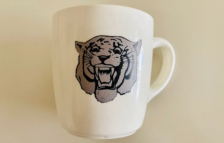 Photo of old coffee cup with faded Detroit Tigers’ logo. (Photo property of author).