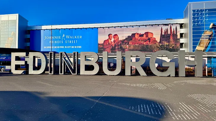 Image of the Edinburgh sign at the airport - image courtesy of the author.