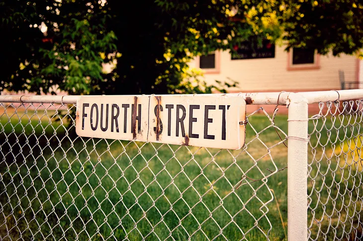 chain link fence with a sign that says fourth street