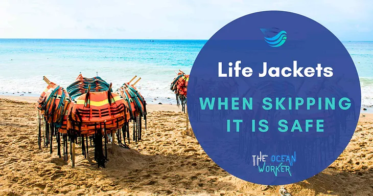 Orange life jackets neatly stacked on racks on a sandy beach, with the ocean in the background. The image emphasizes the importance of life jackets for safety during water activities, with the text “Life Jackets: When Skipping It Is Safe” overlayed.