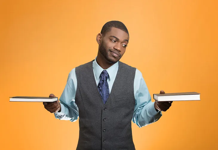 Man choosing between two books