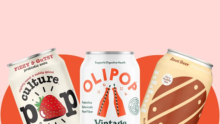 A can of culture pop strawberry, Olipop vintage cola, and poppi root beer