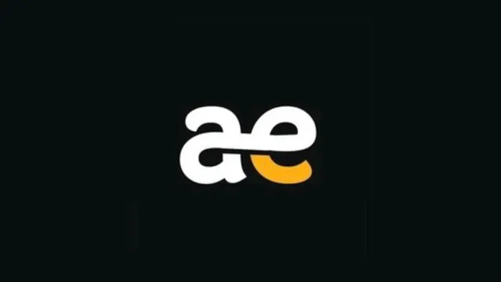 The author created this image of the letters ‘ae’ in white, lowercase script, with the aperture of the ‘e’ in mustard yellow, centered on a black background using Canva and Picsart.