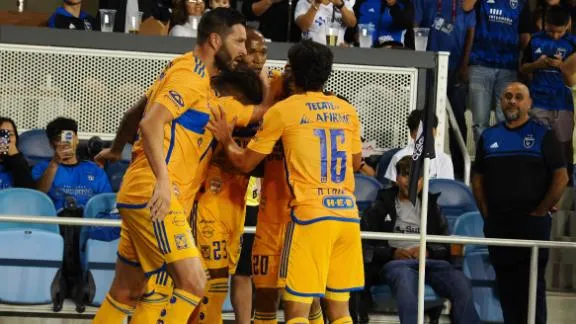 Tigres players celebrate their decisive goal of the match