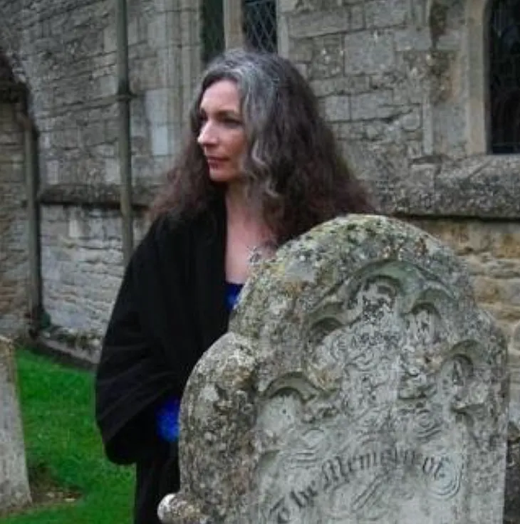 author standing by an old headstone