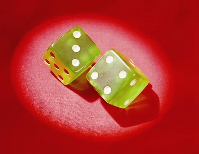 Pair of green dice showing luck seven