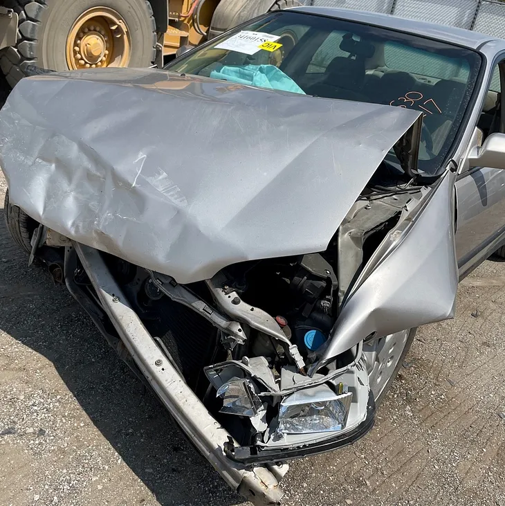 Smashed front end of the author’s car after an accident