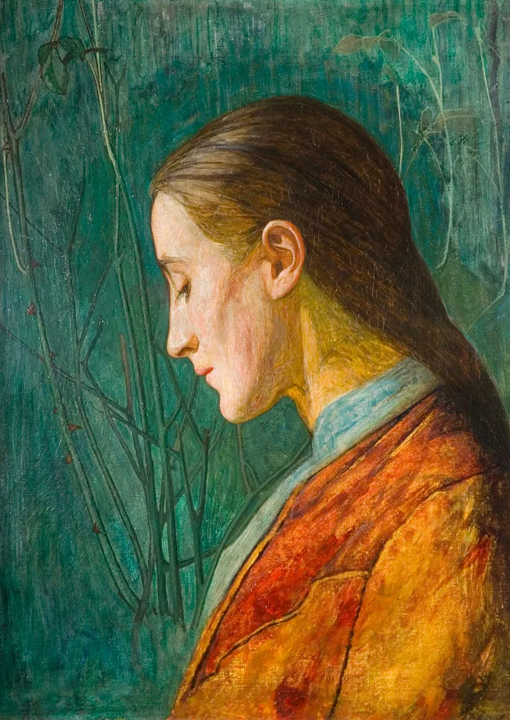 portrait of a reflective person with closed eyes and bowed head wearing orange against a teal background