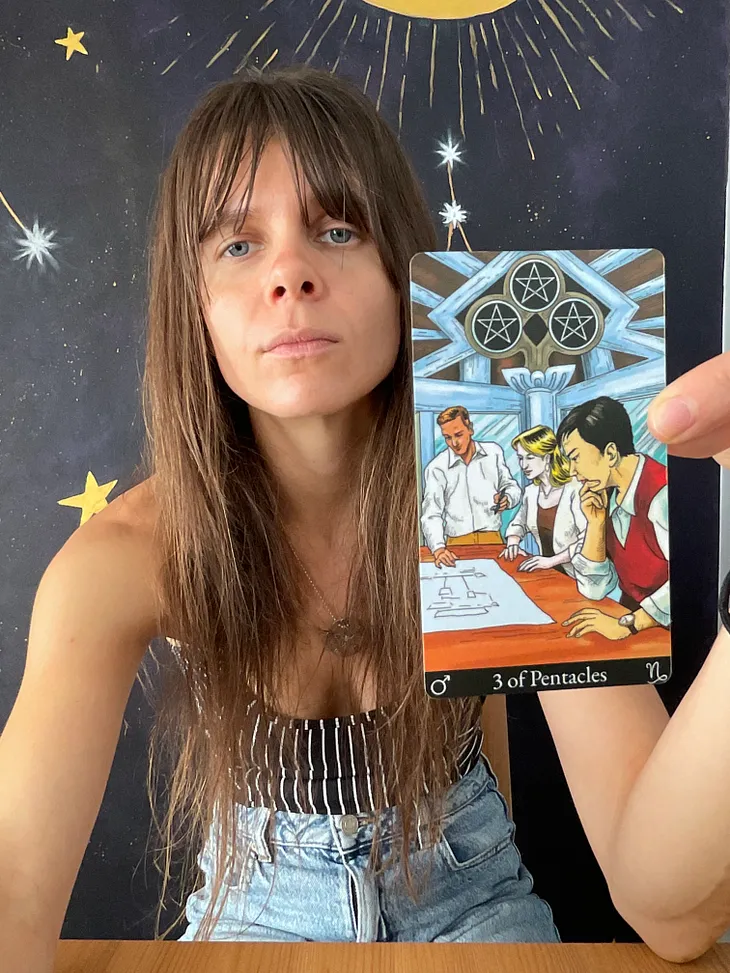 Rozalia Kieliszkiewicz holding the Three of Pentacles, Minor Arcana Tarot Card.