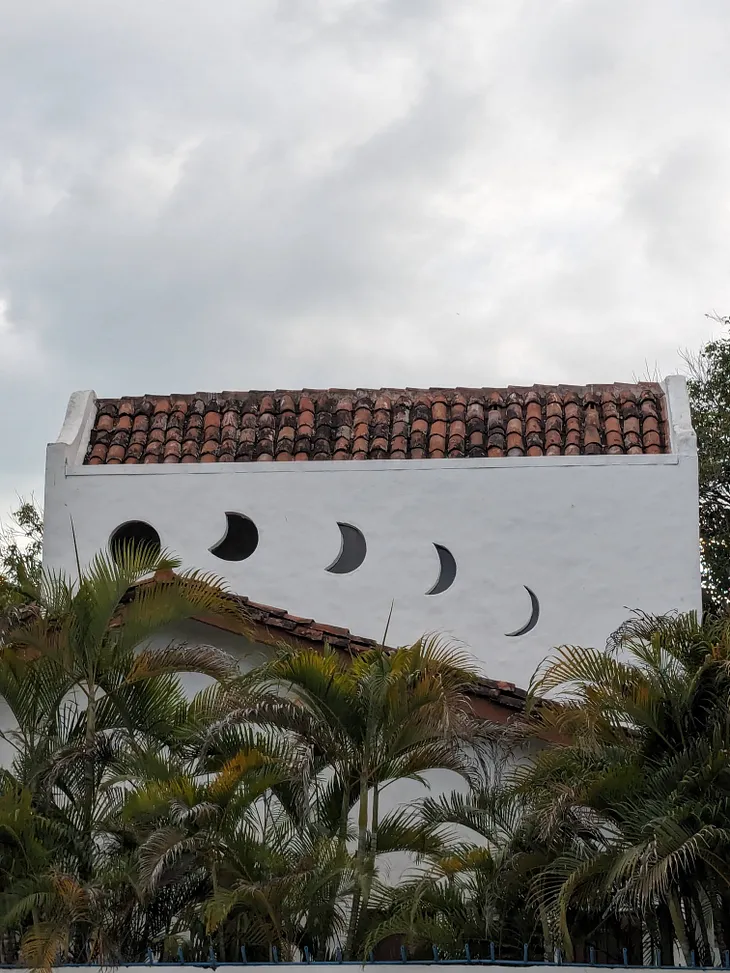 Building with moon phases incorporated into its design, related to an article about cannabis and lunar cycles.