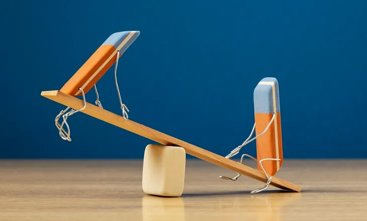 A photo of two animated erasers on a seesaw.