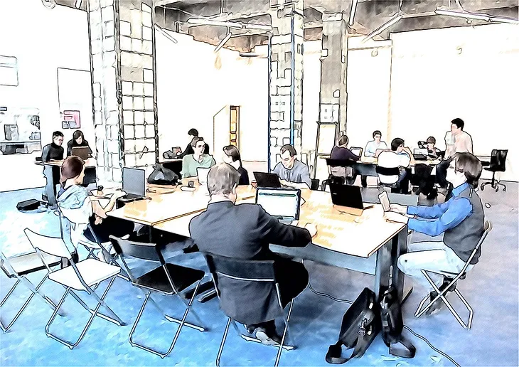 A stylized illustration of an open office space showing multiple people sitting at shared tables with laptops, appearing to be in a co-working or modern workplace environment. The room has industrial-style ceilings and folding chairs, with workers dressed casually.
