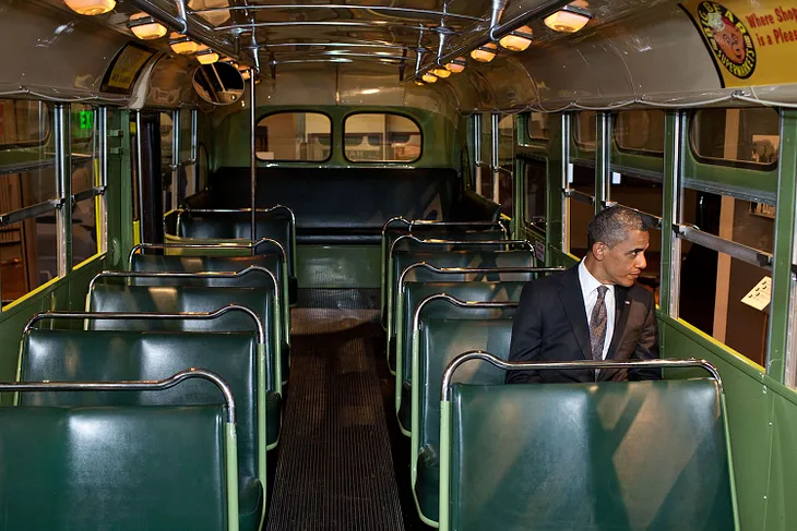 President Barack Obama sits on the bus where Rosa Parks changed history, sparking the civil rights movement. She was told to move to the back of the bus to make room for a white passenger, and she refused to move. Obama has also refused to move, remaining the most important Democratic leader 20 years after he burst onto the national stage and more than seven years since leaving the White House. The bus is displayed at the Henry Ford Museum in Dearborn, Michigan. White House photo.