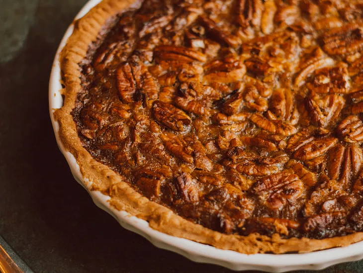 A fresh baked pecan pie with a crispy crust.