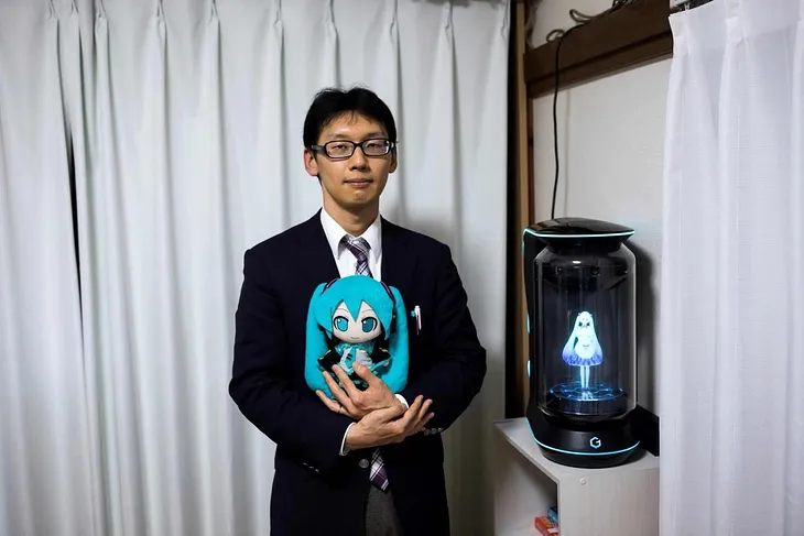 Akihiko Kondo standing with Miku, a hologram wife