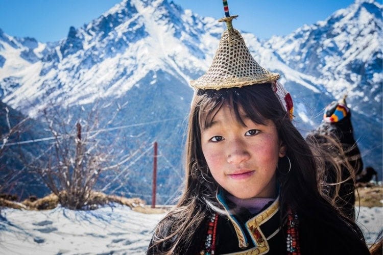 Young girl in traditional dress in the high Himalayas. Photo by Matthew DeSantis, courtesy of MyBhutan