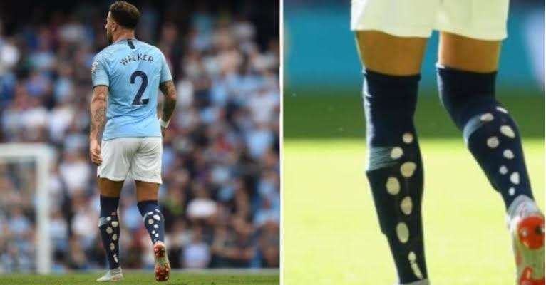 Explained: Why do footballers cut holes in their socks?