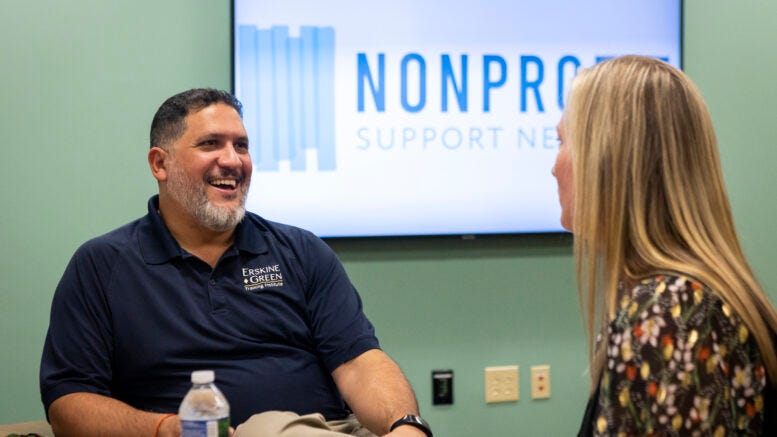 Daniel Gurule, Manager of Donor Relations for The Arc of Indiana Foundation and Erskine Green Training Institute interacts with Mandy Williams, Vice President of Programs at LifeStream Services, Inc., during a peer group meeting in 2022. (Credits: Muncie Journal)