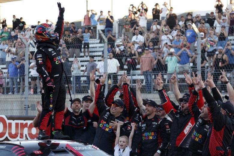 Tyler Reddick climbs on top of his №45 Toyota in elation after winning his third consecutive Cup Series race to start the 2026 season. (Image Credit: Logan Riely | Getty Images)