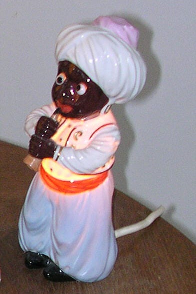 an old toy with black skin and big red lips