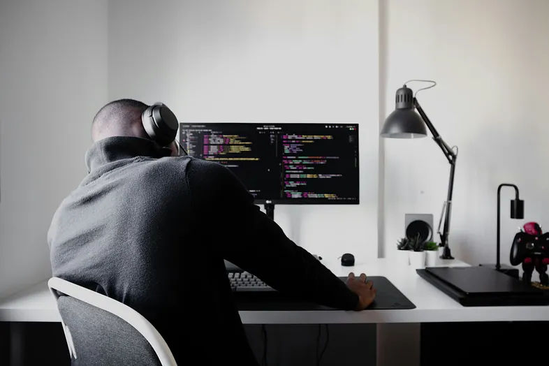 A skilled programmer exhausted by working on a bug, and killing his time