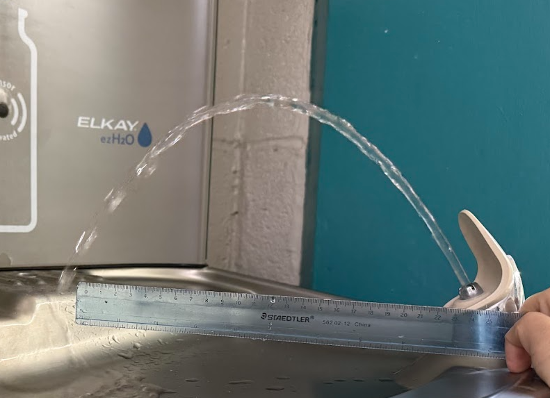 Water from a fountain. Is it parabolic? Ruler for scale.