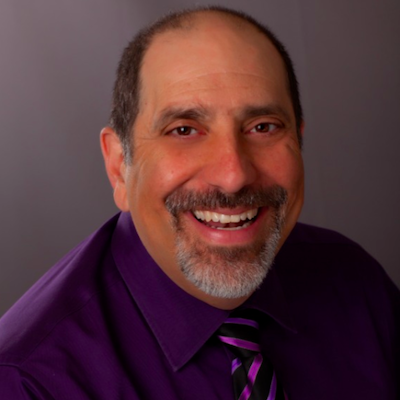 A portrait of Aram Boyd with a mustache and a short gray goatee.