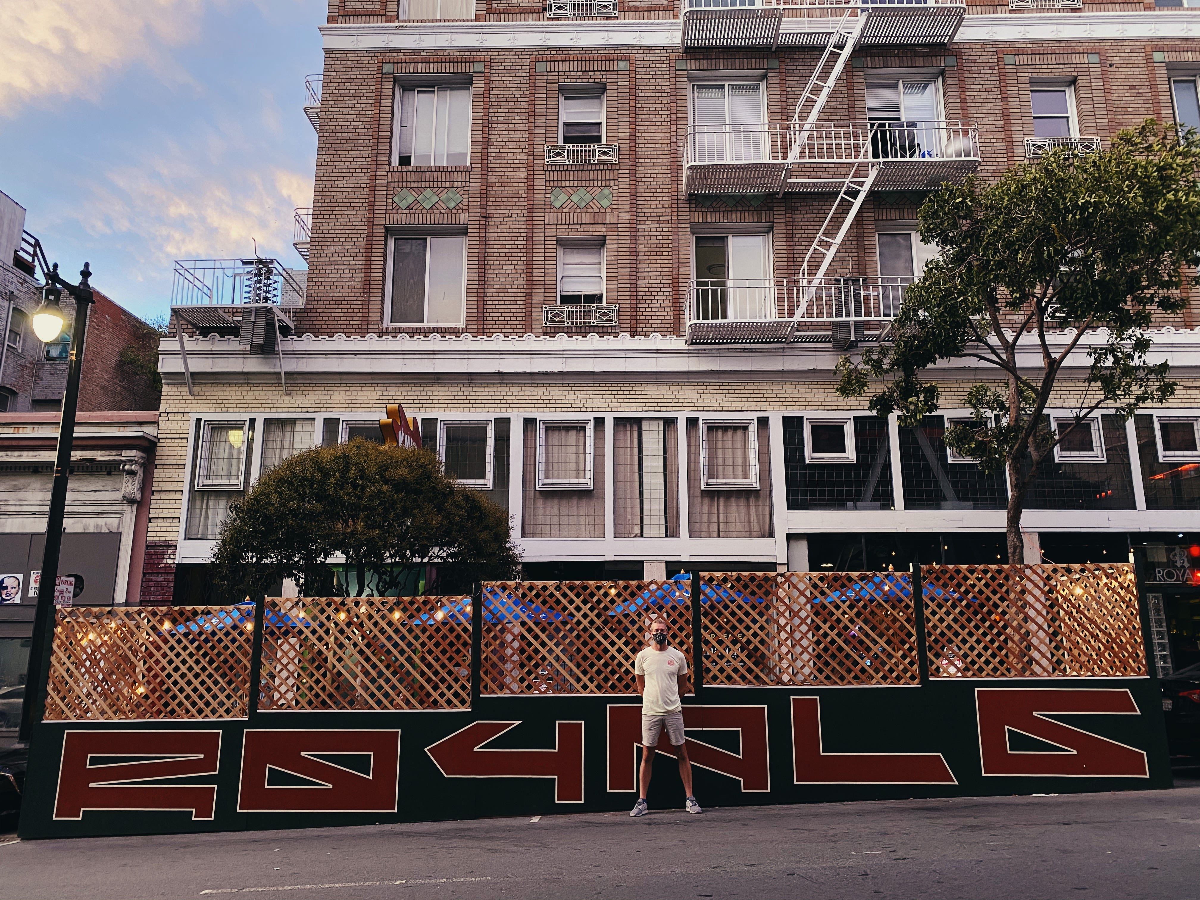 An outdoor dining space constructed in front of a restaurant on a city street.