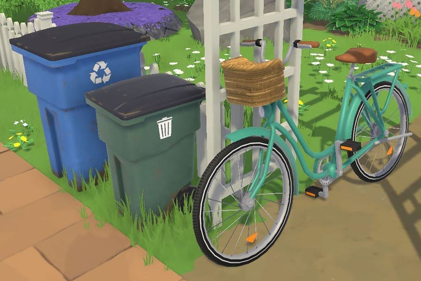 Gros plan sur les poubelles et le vélo. Veuillez noter que les poubelles, d’inspiration très canadienne, ne seront pas les seules options disponibles, et que le vélo n’est actuellement pas fonctionnel en tant que moyen de transport !
