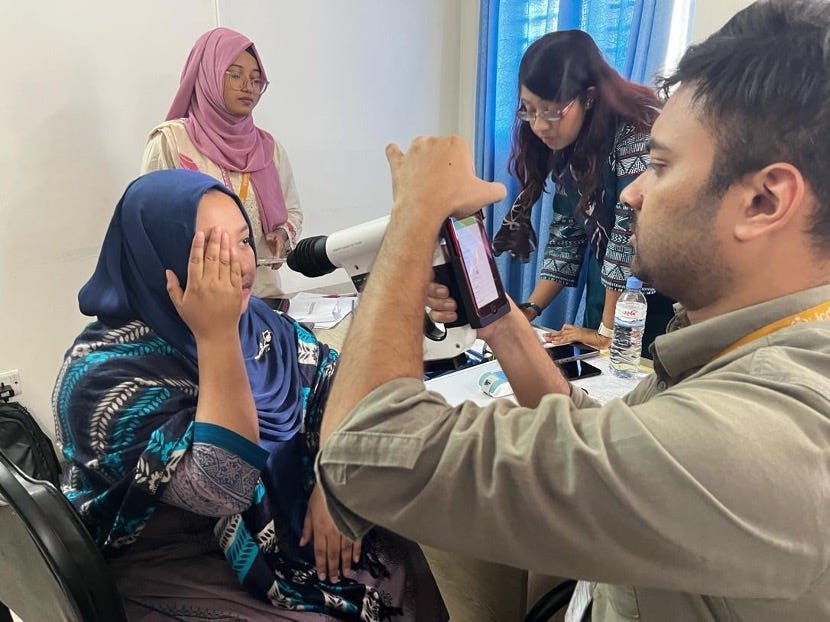 Dr. Tarikul Islam and nurse Tamanna Akter practicing retinal imaging capture steps using a Remidio camera during a training session at icddr,b. Photo credit: Hiba Babiker
