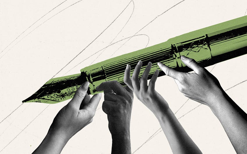 Image of a giant pen being held by many hands.