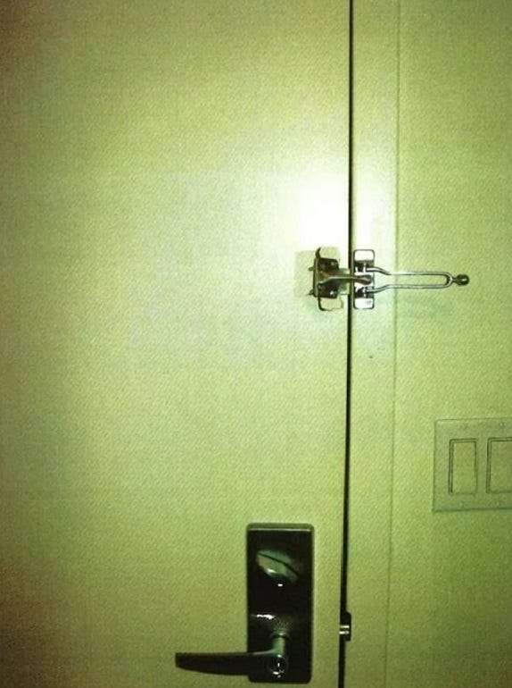 An interior shot of the apartment door after Sam allegedly forced his way in.