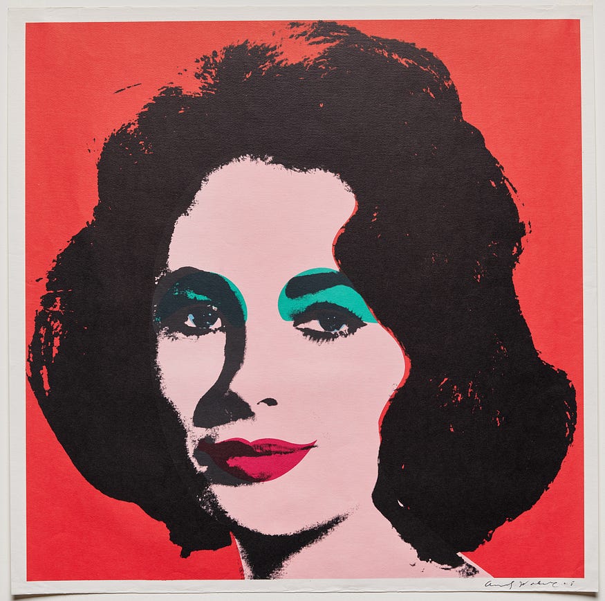 Flat, stylized, and colorful print of Elizabeth Taylor from the neck up. She has chin-length, voluminous and slightly wavy black hair and dark streaking eyelashes. The outline of her face is created in black ink. The background is inked red, her lips a reddish-pink, her face a pale pink, and her eyelids in teal. Pale blue faintly rims her irises. All of these colors bleed slightly outside their edges.