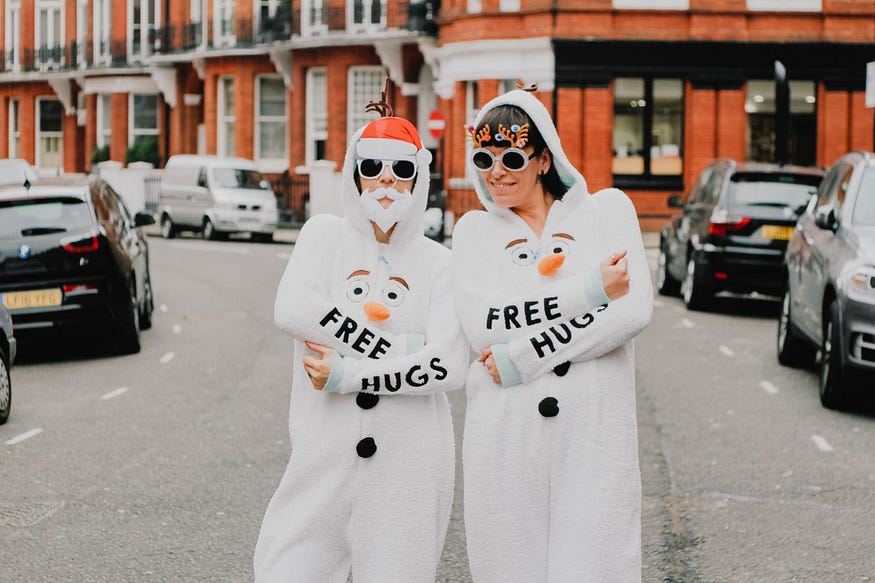 Two people advertising free hugs