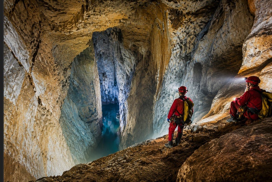 Far below the surface, a vast underground world unfolds — an alien landscape carved by water, time, and unimaginable geological forces — ChatGPT