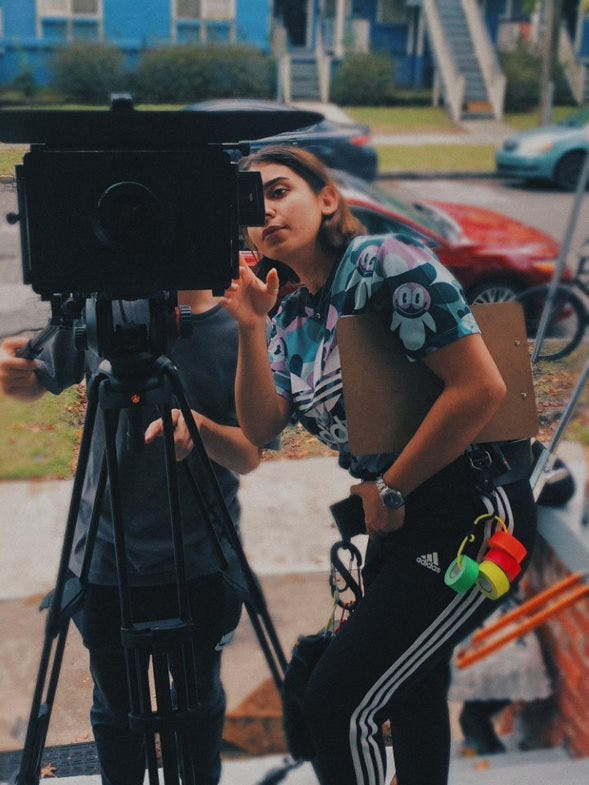 Deena directing behind camera