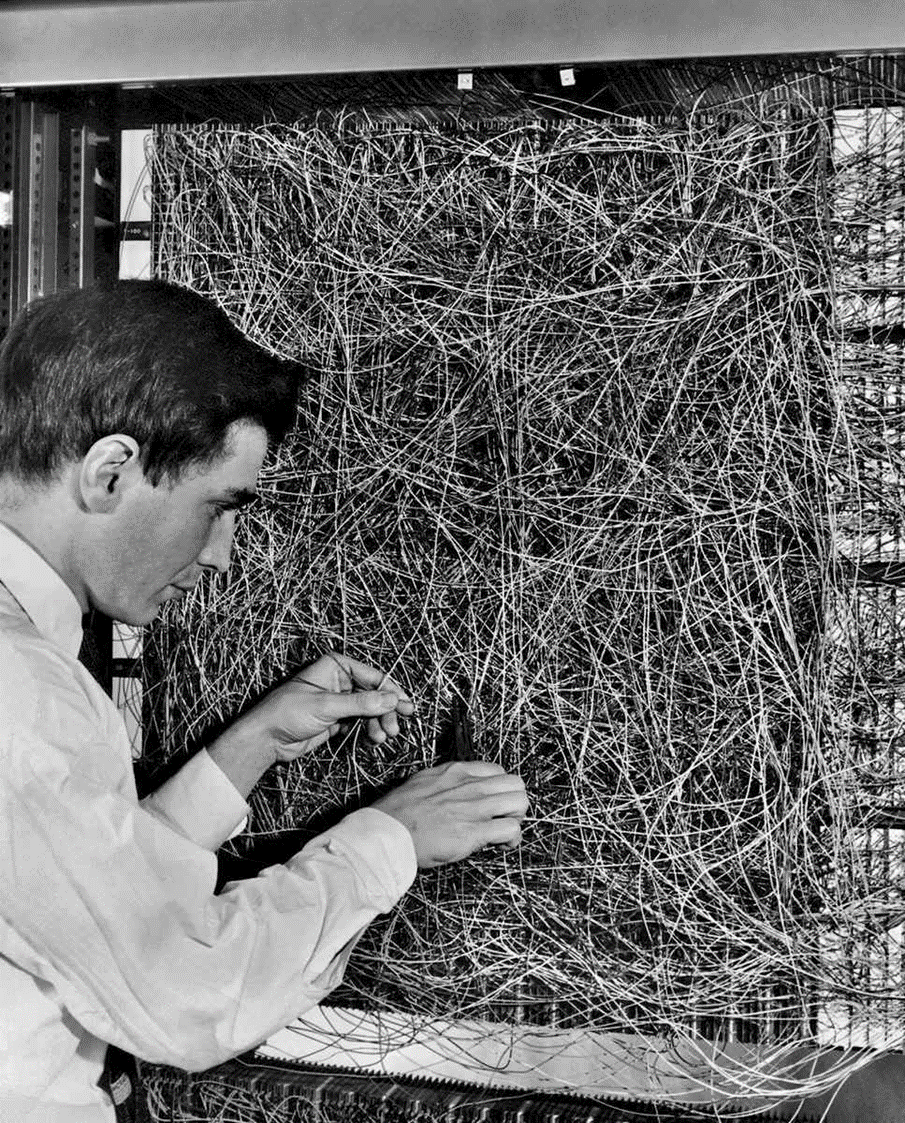 Frank Rosenblatt stands beside the Mark I Perceptron at Cornell Aeronautical Laboratory, 1960. The machine represents the first successful hardware implementation of a learning algorithm.