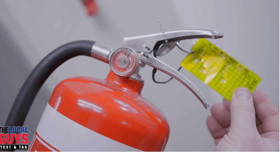 Checking a Fire Extinguisher. Fire extinguisher test and tag is… by