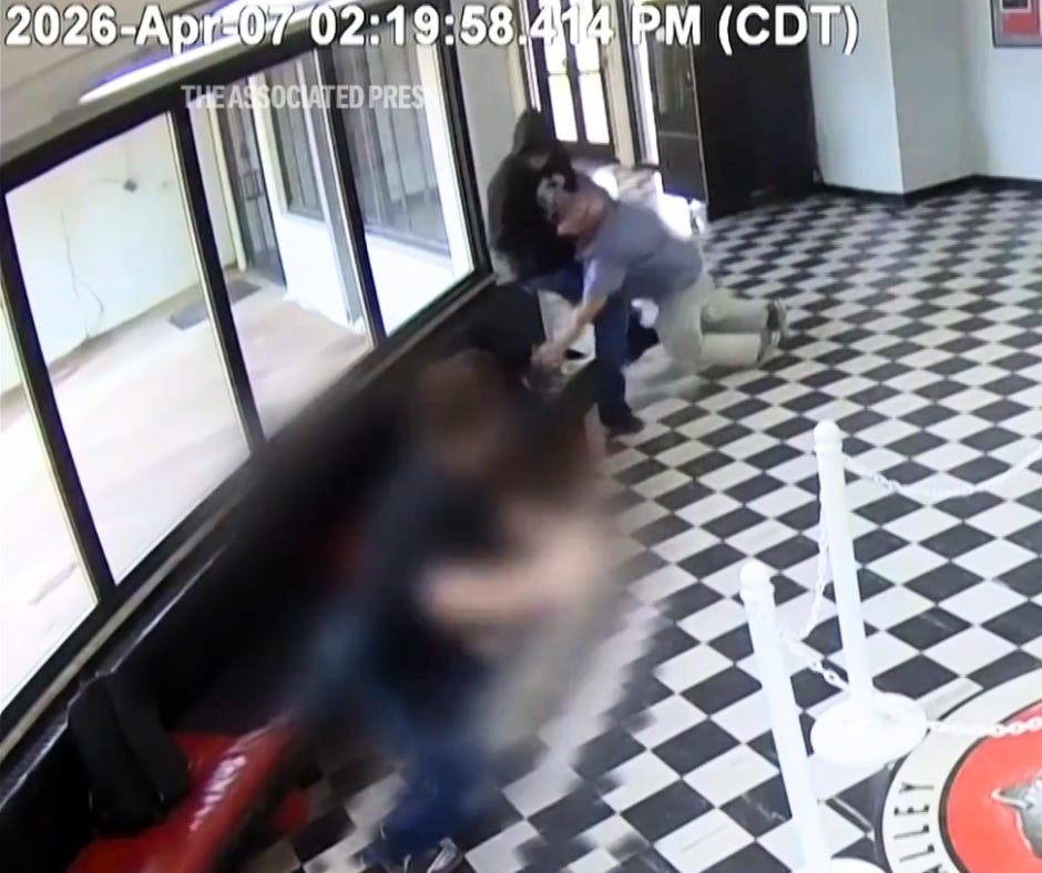 Screenshot of AP video showing Principal Moore disarming a man in the lobby of Pauls Valley High School.