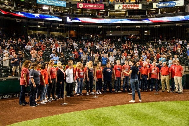 People standing on a baseball field.