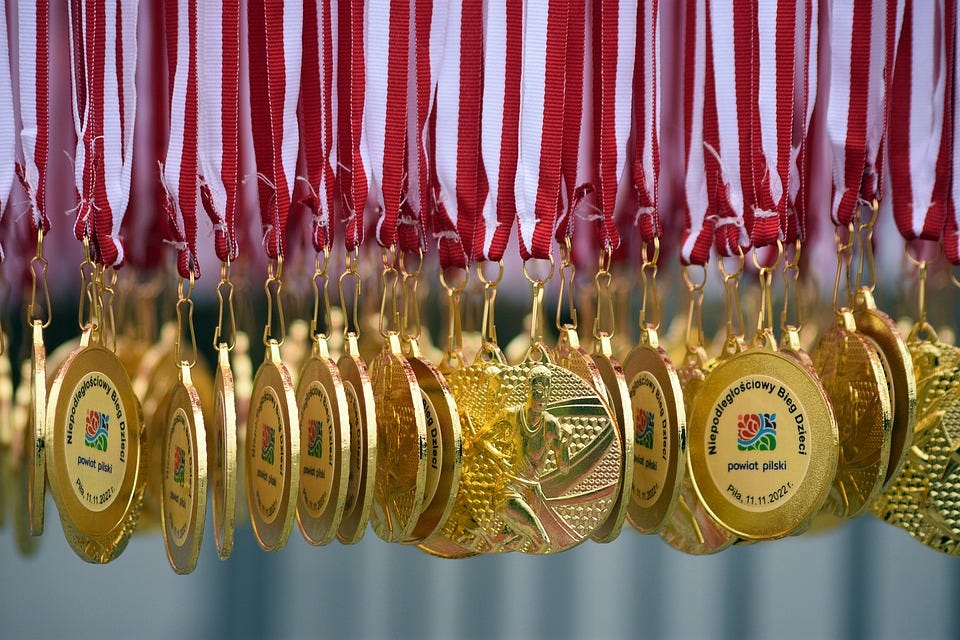 Understanding the Difference Between Medals and Trophies: A ...