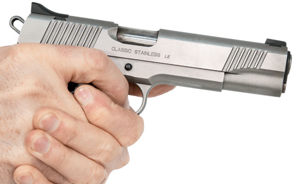How should you hold a handgun for maximum accuracy by