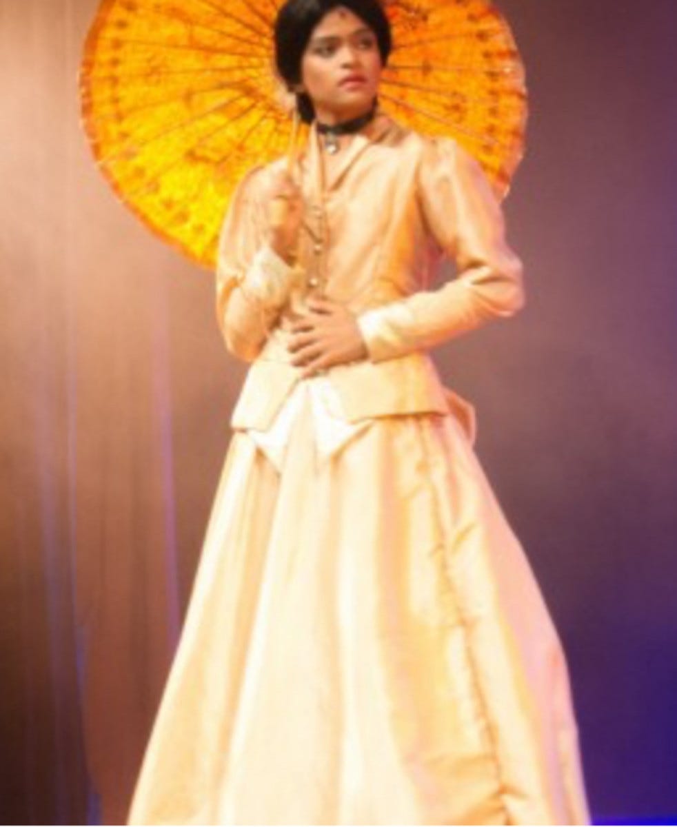A boy plays a woman’s role in a rendition of “Around the world in eighty days” at a tropical Sri Lankan school. Politics don’t enter here — this is from a boys school and duty calls.